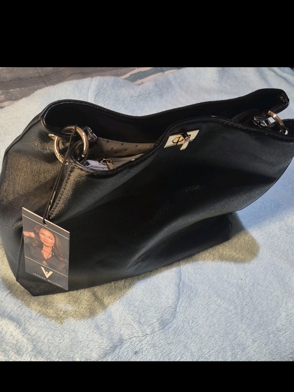 Versatile Black Shoulder Bag with Gold Hardware